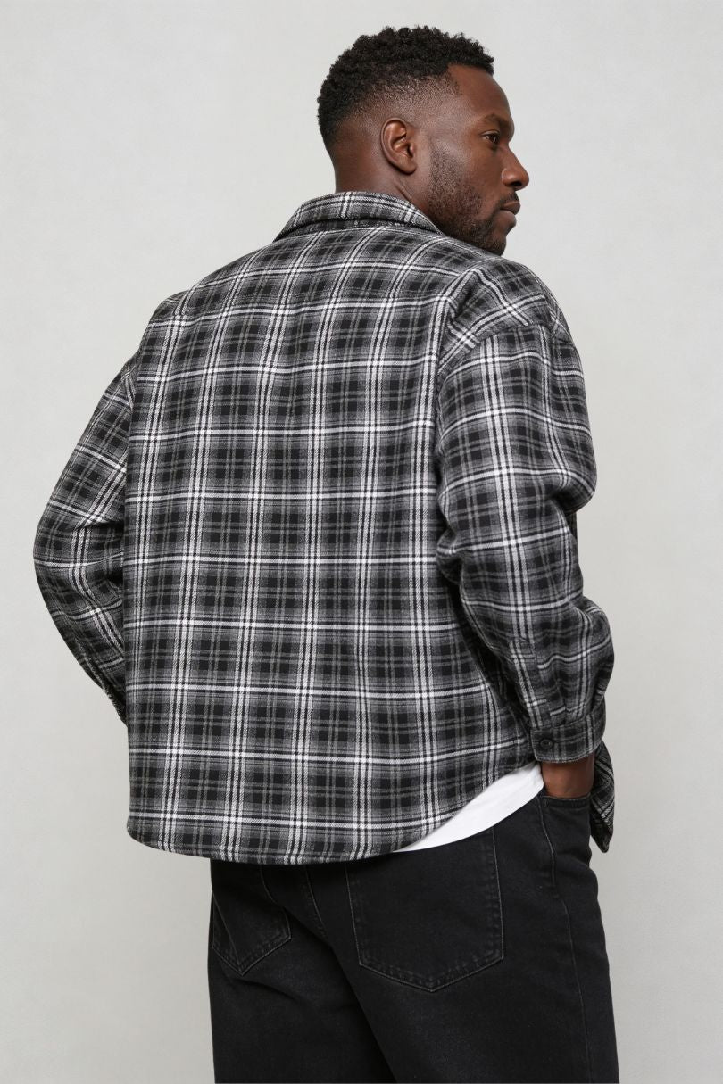 Men's black plaid button shirt worn as casual overshirt back view