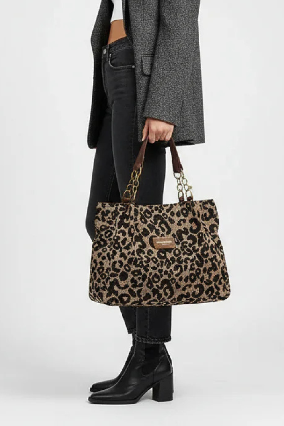 Woman wearing leopard tote styled with blazer, shoulder carry