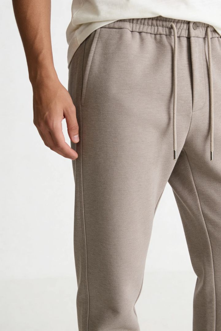 Men’s wool blend drawstring trousers in sand taupe – close-up view
