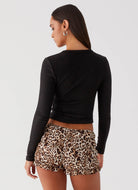 Back view—women’s black rib knit long-sleeve top