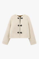 Women’s ivory faux-shearling toggle jacket—cropped, boxy fit, front view.