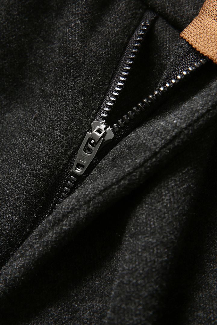 Close-up of a zipper on a dark fabric surface